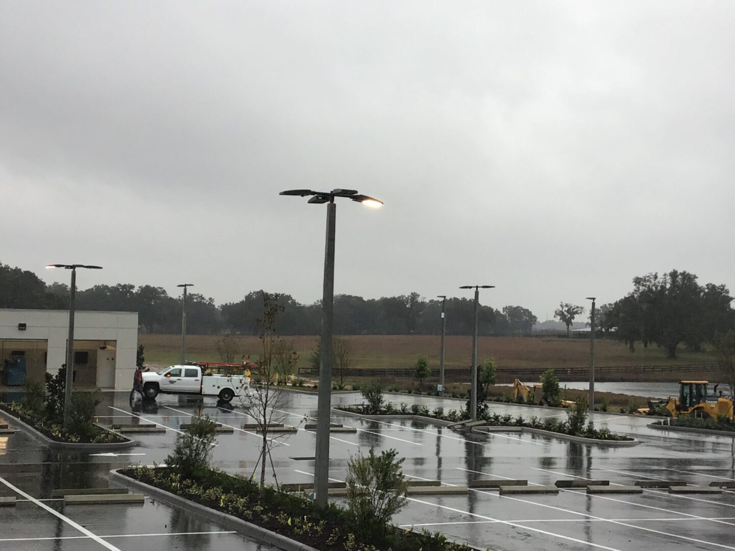 A parking lot with many lights and trees