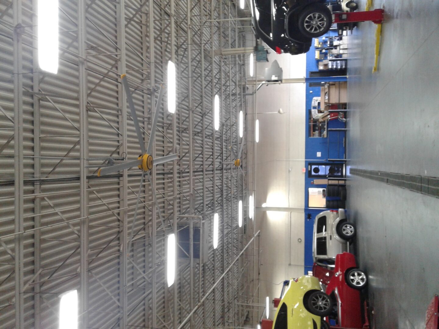 A car shop with several cars on the floor.